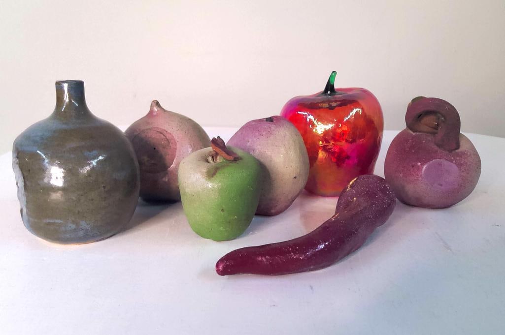 Collection of Studio Pottery and Art Glass Fruit FormCollection of Studio Pottery Fruit and: Group comprising seven decorative objects including a stoneware bottle-form vessel, glazed ceramic apple, two pear forms, two garlic/onion forms, a ceramic chili pepper, and a red art-glass apple. Var