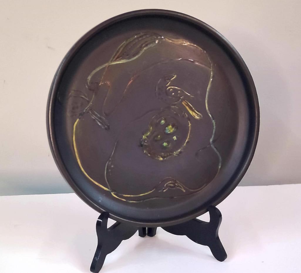Mary Alice Hadley (1905-1965): Early Bird & Acorn Charger, Dated 1949, 1949, Hand-thrown and hand-carved earthenware charger with stylized bird and acorn decoration beneath a dark matte glaze with iridescent accents. Signed 
