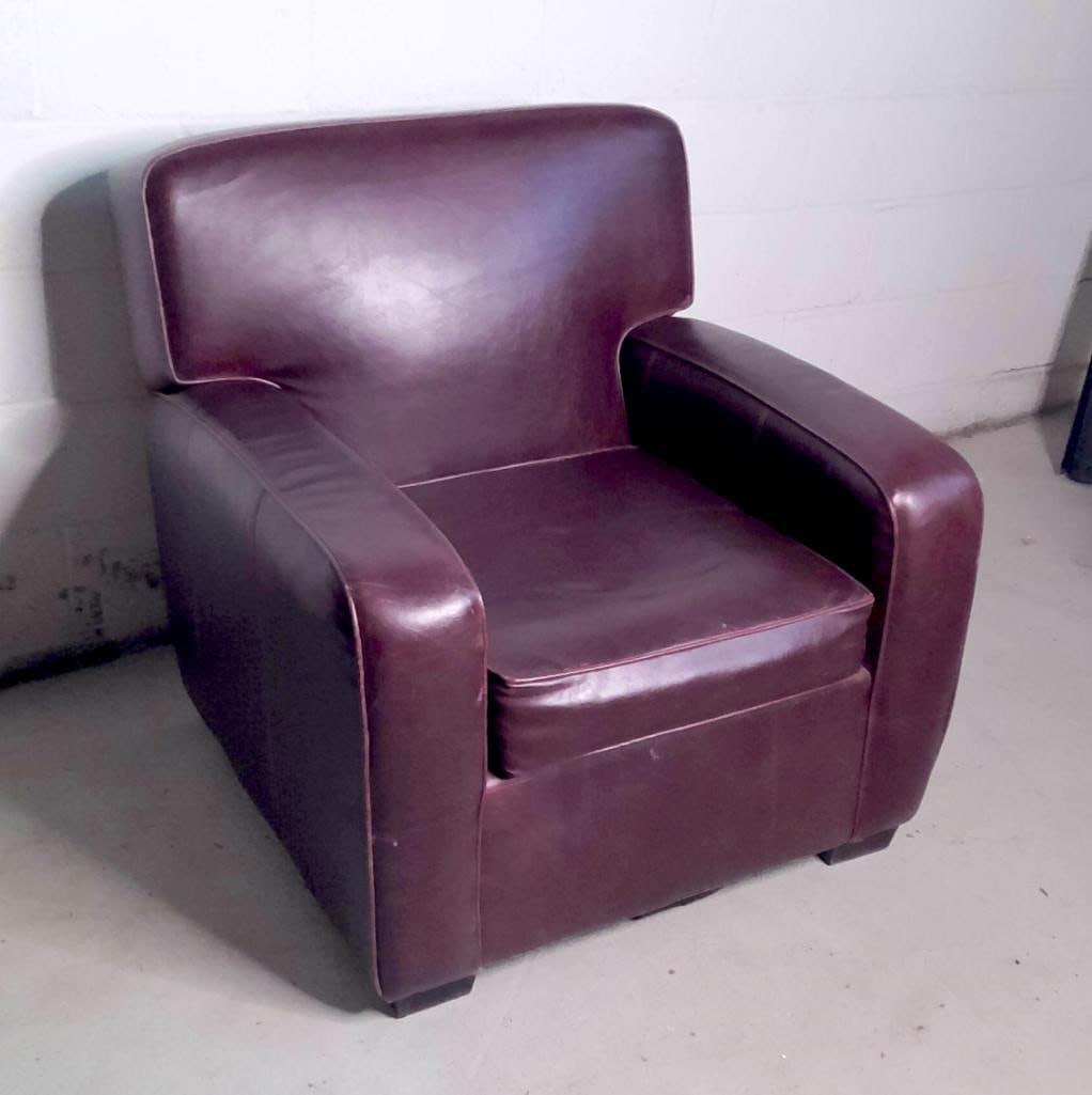 Southfield Leather Club Chair: Oversized upholstered club chair by Southfield LTD, High Point, North Carolina. Executed in deep oxblood/burgundy leather with broad rolled arms, shaped backrest, loose seat cushion, and block feet. T
