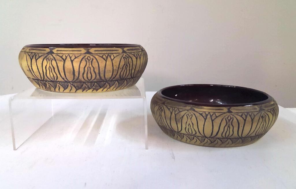Pair of Studio Pottery Decorated Bowls: Pair of hand-thrown studio pottery bowls featuring carved and incised repeating floral and geometric decoration to the exterior. Each bowl is finished with a dark brown glazed interior contrasting wit