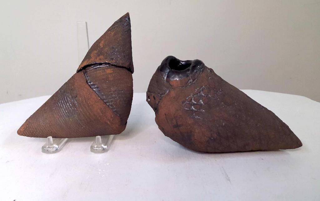 Pair of Abstract Studio Pottery Bird Sculptures: Two hand-built earthenware bird-form sculptures with dark burnished surfaces and incised decoration. One incorporating a vessel opening at the head, the other retaining a detached sculptural element. 
