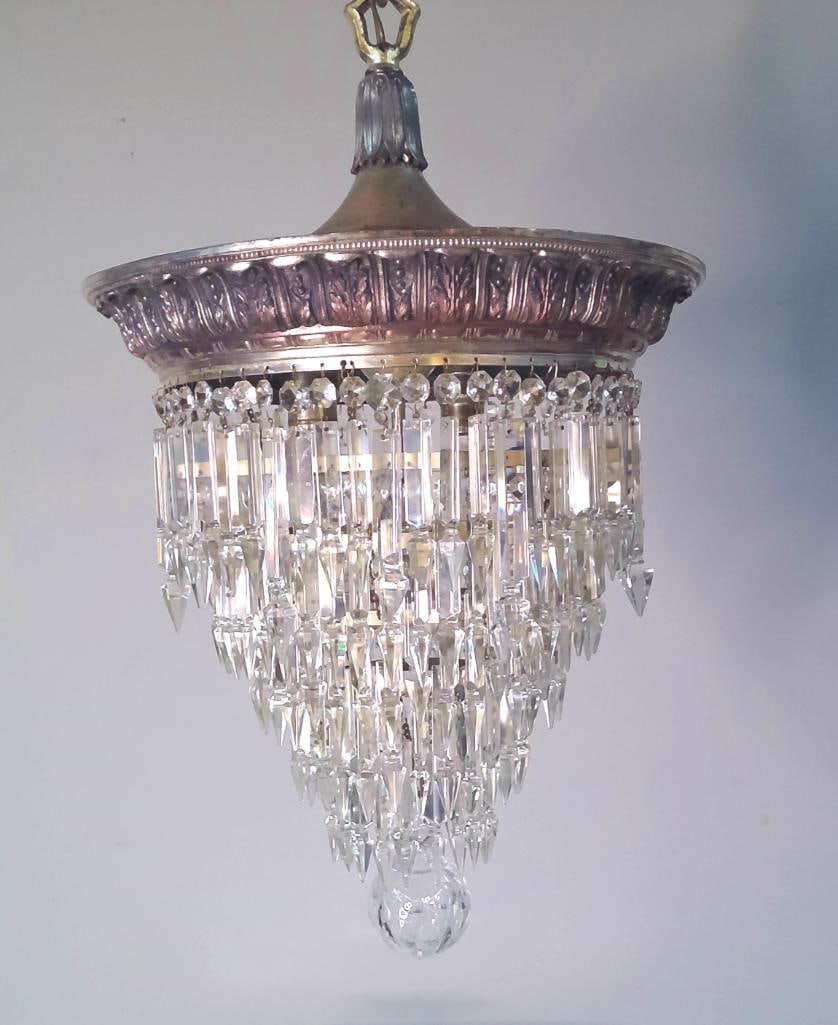 Empire Lighting Co. Waterfall-Form Crystal Chandelier: A vintage silver-tone metal chandelier in the waterfall or "wedding cake" form, fitted with graduated faceted crystal prisms arranged in cascading tiers and terminating in spear-point drops. S