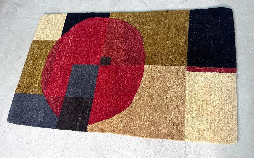 Contemporary Hand-Tufted Wool Geometric Area Rug: Contemporary hand-tufted wool area rug featuring an abstract geometric composition with a large crimson circular form set against blocks of black, olive, taupe, gray, and cream. The modernist design r