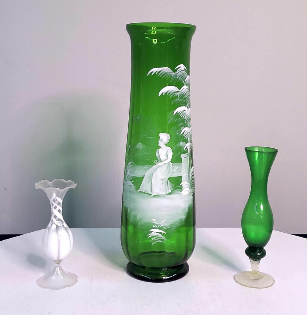Three Vintage Art Glass Vases, Including Mary Gregory-Style Figural Vase: Three Vintage Art Glass Vases, Including Mary Gregory-Style Figural Vase A group of three vintage art glass vases comprising a tall emerald-green cylindrical vase decorated in white enamel with a seat