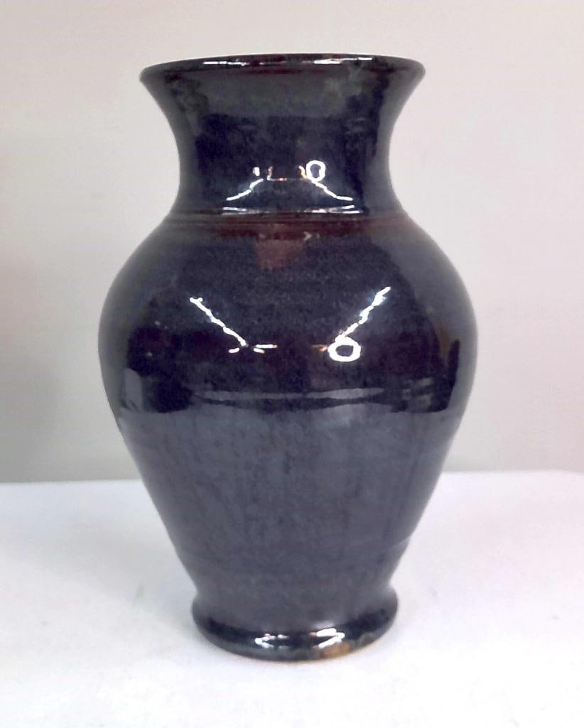 Southern California Studio Pottery Vase: Possibly Palm Springs Area, late 20th century. Wheel-thrown stoneware vase of baluster form with flared rim, finished in a mottled blue-black reduction glaze with brown undertones. Raised on a