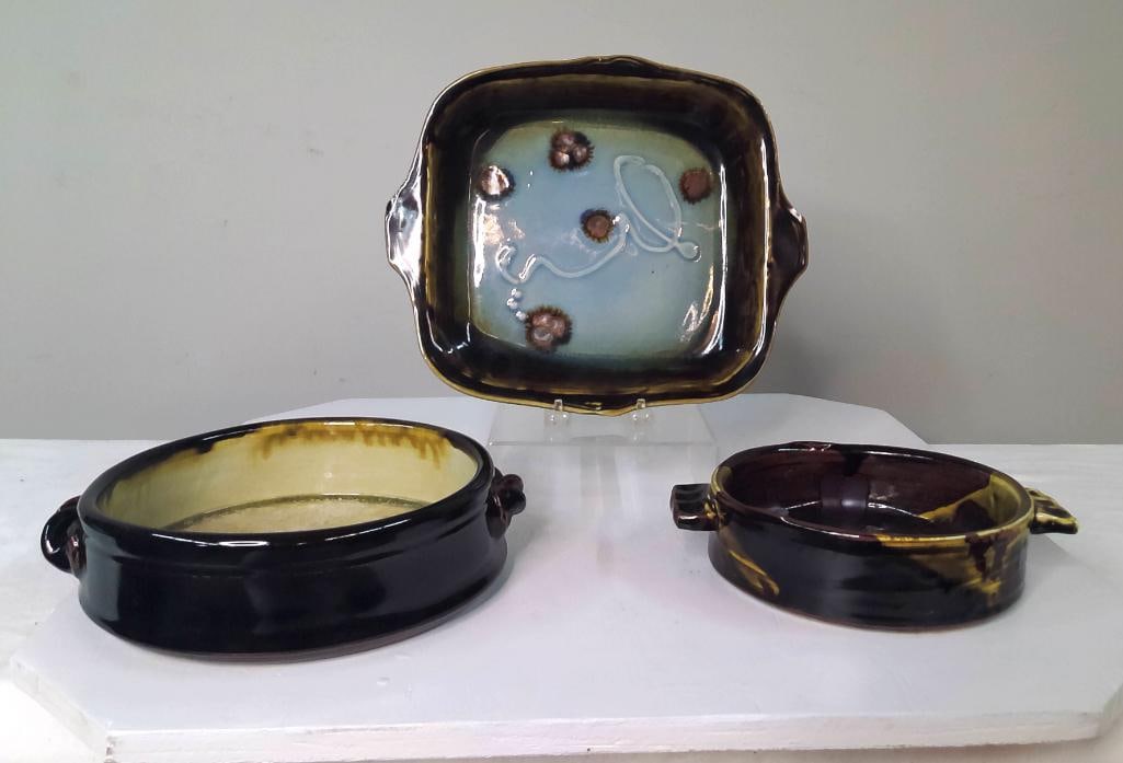 Three Studio Pottery Serving Articles, One Signed Martin: Group of three studio pottery serving articles including a signed round bowl, square handled serving tray, and handled baker. Decorated with earth-tone, cream, and blue-green glazes, including crystal