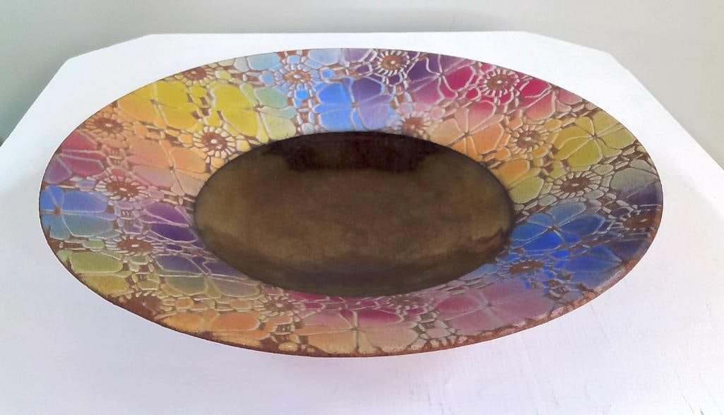 Sarah Frederick Rainbow Floral Charger Bowl: Hand-thrown and hand-decorated stoneware charger by Sarah Frederick, featuring a broad, shallow circular form with elevated foot. The interior is embellished with an intricate floral lacework pattern 