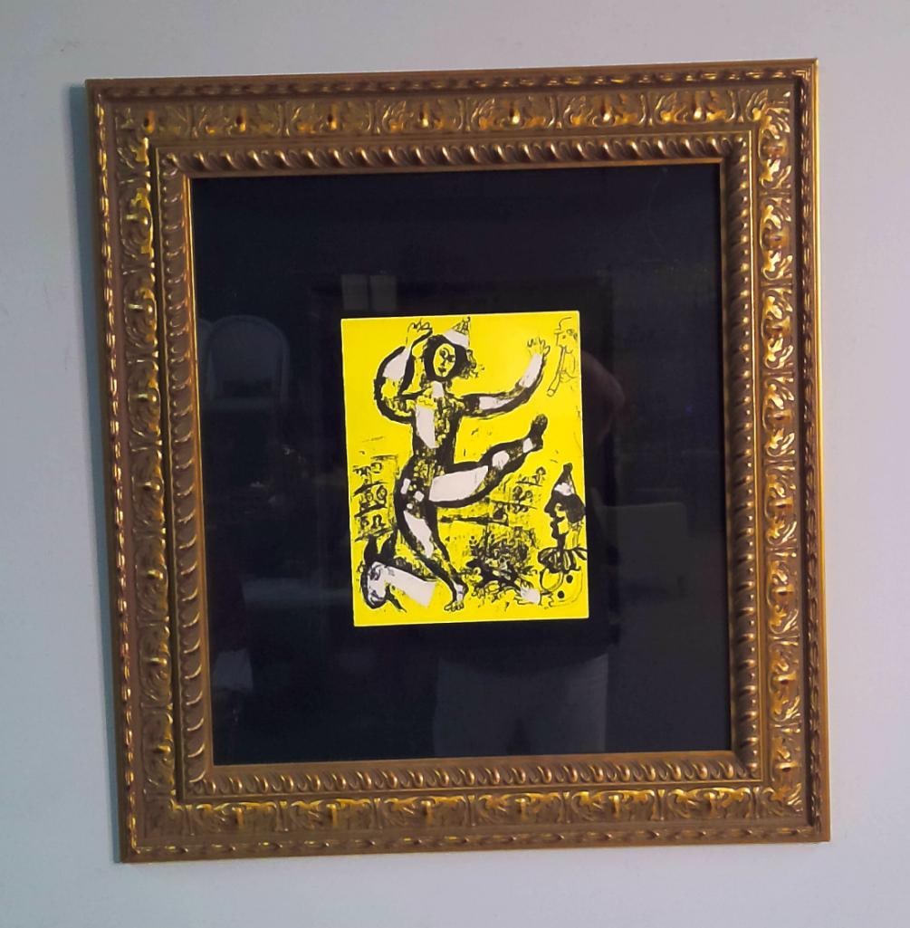 After Marc Chagall (Russian-French, 1887–1985): Le Cirque, depicting a costumed acrobat performing upon horseback, surrounded by musicians and circus figures against a vivid yellow ground. Color lithographic Signed lower right in pencil; numbered l