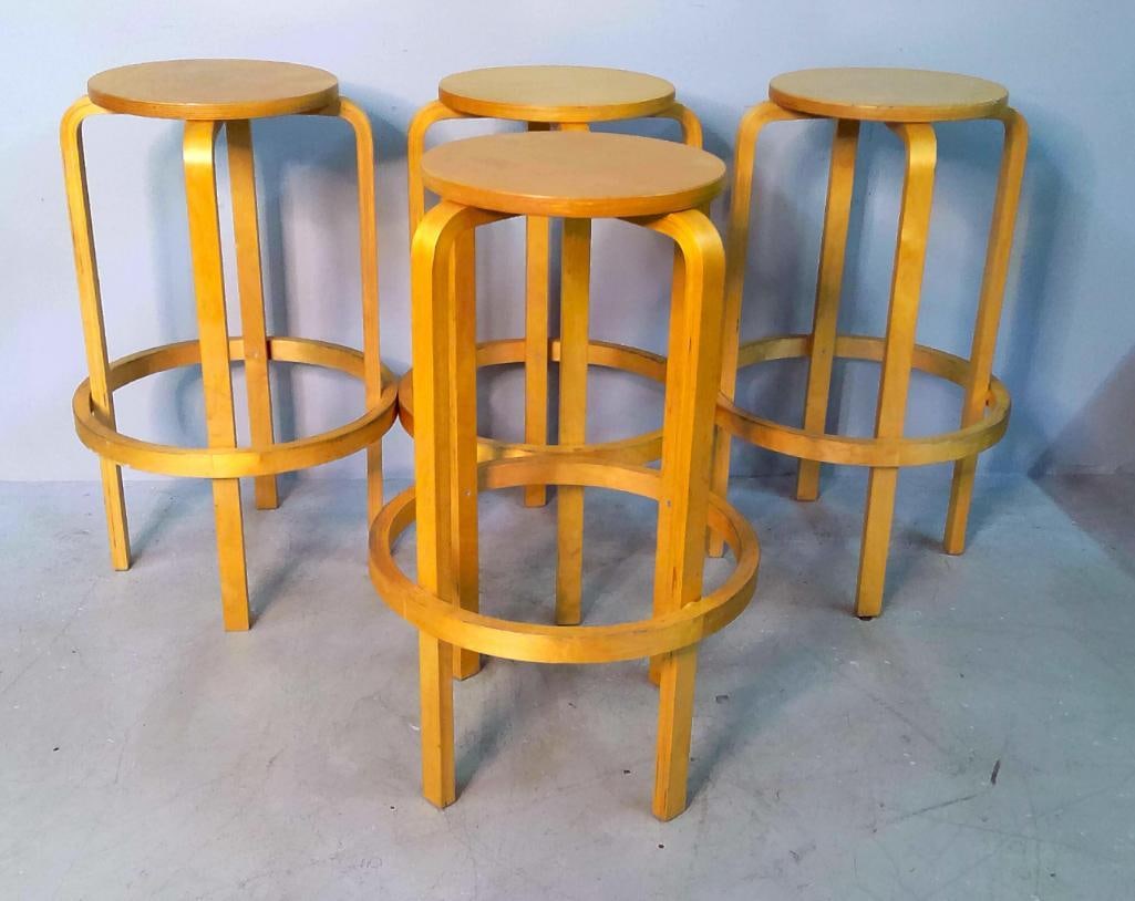 Attributed To Alvar Aalto For Artek Model 64 Bar Stools: Set of four Scandinavian Modern bar stools attributed to Alvar Aalto for Artek, Model 64, originally designed in 1935. Each constructed of clear-lacquered birch with a circular plywood seat, four lami