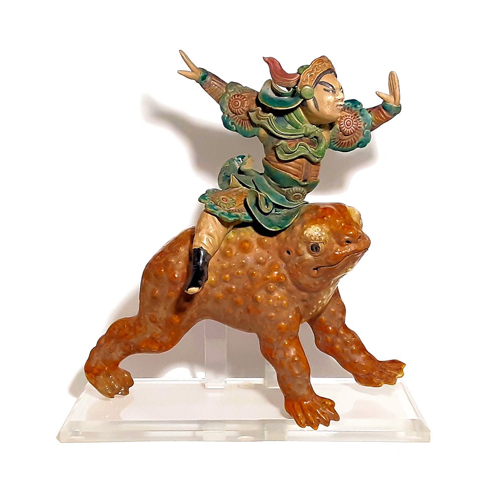 MING FIGURAL ROOF TILE ORNAMENT SANCAI GLAZE: MING FIGURAL ROOF TILE ORNAMENT SANCAI GLAZE EARTHENWARE IMMORTAL LIU HAICHAN. The Ming sancai terracotta tile mounted on a lucite stand. It shows a figure riding a three-legged toad, possibly the imm