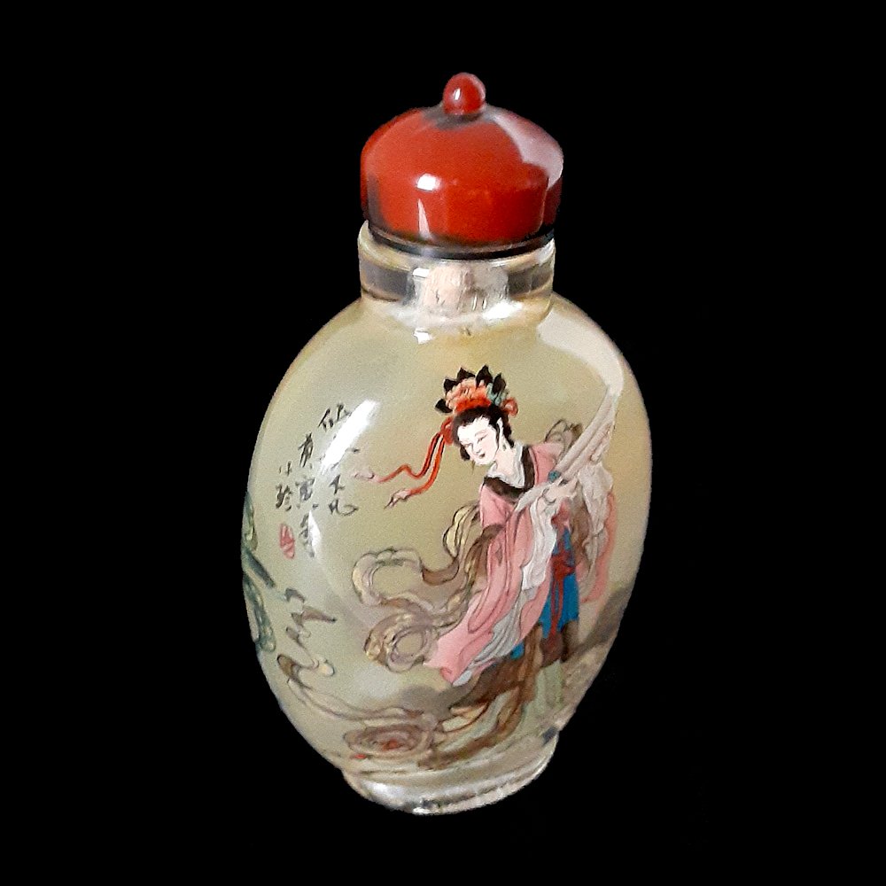 INSIDE PAINTED SNUFF BOTTLE ARTIST PEN NAME QUI SHI: SIGNED CHINESE INSIDE PAINTED SNUFF BOTTLE DEPICTING FEMALE IMMORTAL.Artist signed and with an agate stopper. ARTIST LIU XIN (G) KAI, PEN NAME QUI SHI.H: 3.9Â”, 10 cm.Provenance: Private Florida co