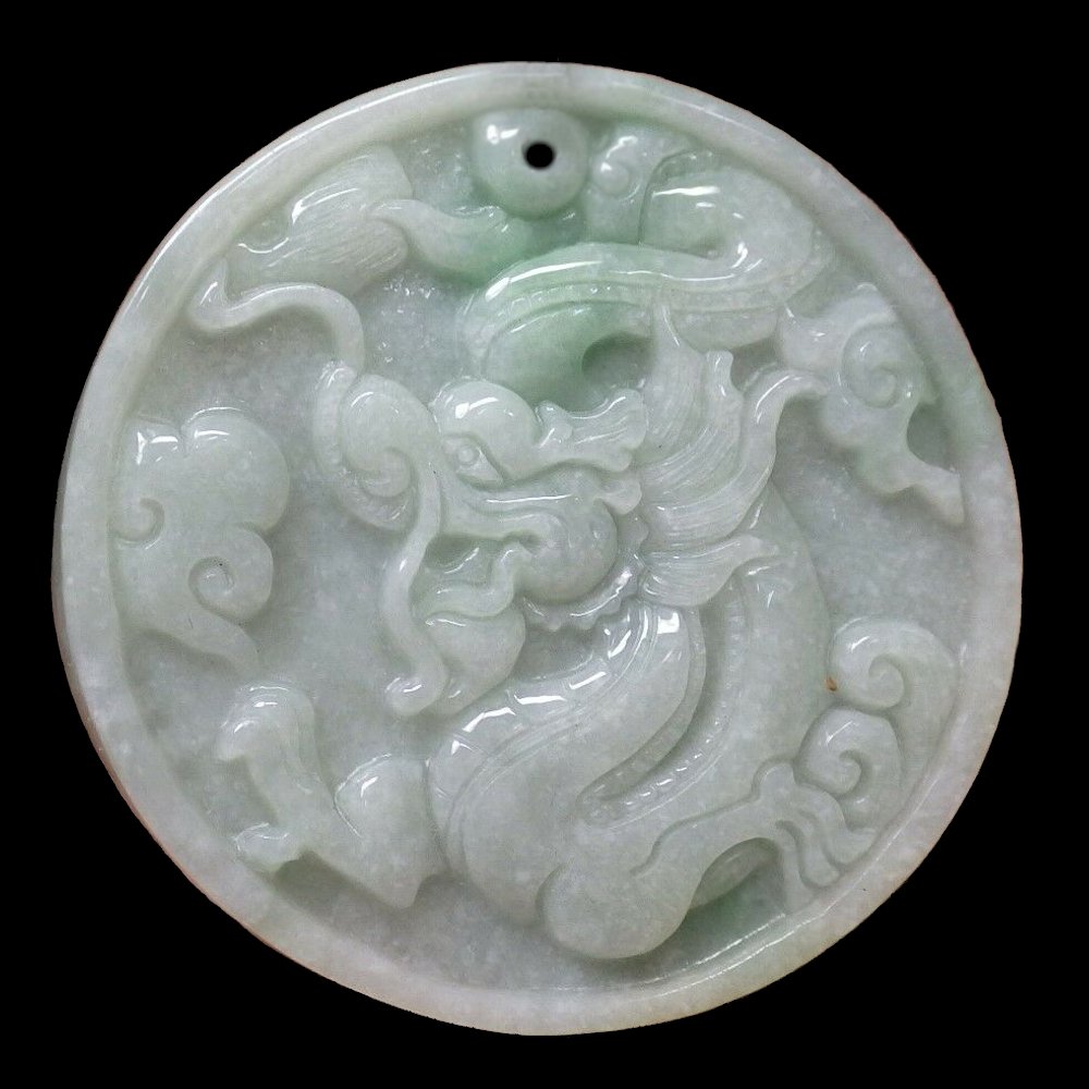 EXCELLENT JADEITE CARVING PENDANT DRAGON CLOUDS: THE FINE CIRCULAR PENDANT DEPICTING A DRAGON WITH CLOUDS.53 MM IN DIAMETER.PROVENANCE PRIVATE FLORIDA COLLECTION.