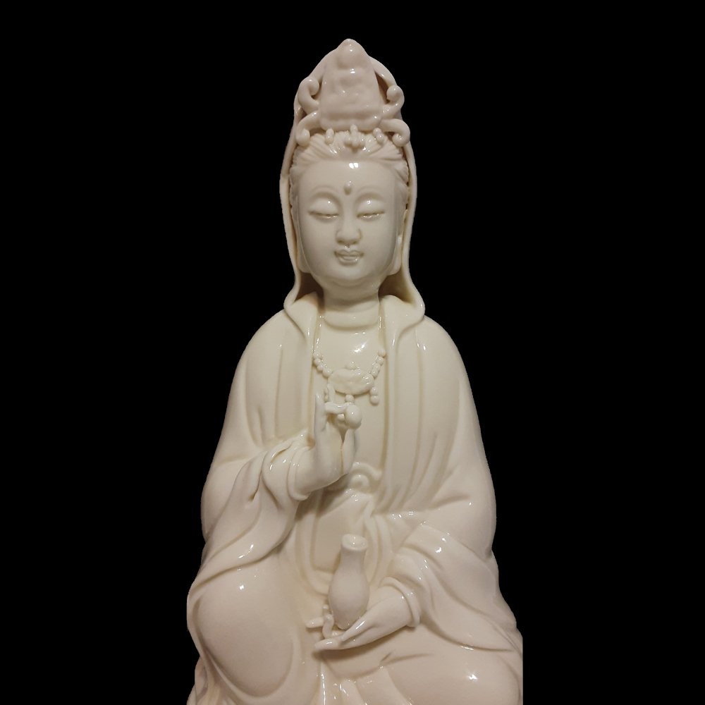 SUPERB PORCELAIN BLANC DE CHINE DEHUA STATUE GUANYIN: The very fine statue of Guanyin, Quanyin, done with great delicate detail. Signed on the back and in excellent condition. Seated on a carved wooden stand, deep in serene meditation. With incised perio