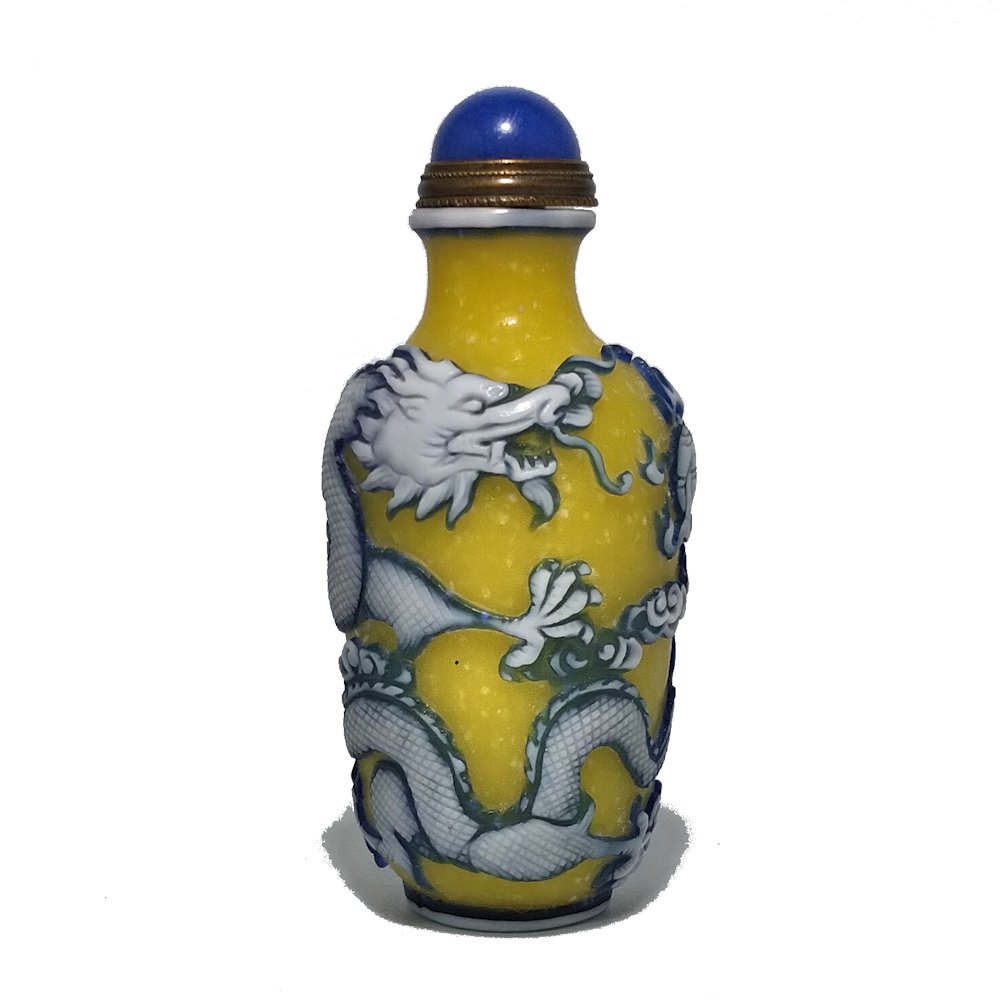 PEKING GLASS SNUFF BOTTLE IMPERIAL DRAGON QIANLONG: THE BUBBLE INFUSED YELLOW GLASS BOTTLE IS FINELY CARVED IN THREE LAYERS OF GLASS. IT DEPICTS A FIERCE 5 CLAWED IMPERIAL DRAGON WITH FINE DETAIL. THE BOTTLE BEARS A QIANLONG CARVED SEAL. THE FOOT IS VE