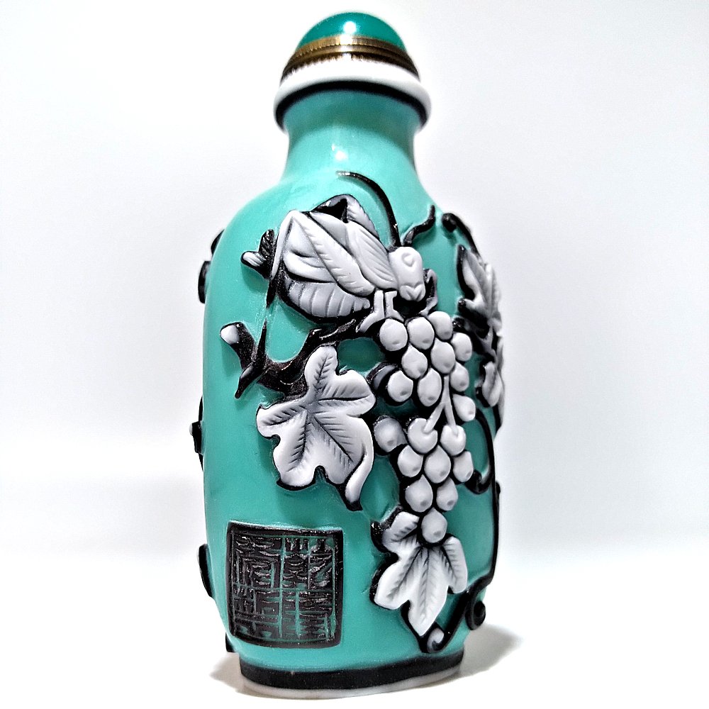 FINE PEKING GLASS SNUFF BOTTLE SQUIRREL GRAPES SIGNED: THE FINE SNUFF BOTTLE CARVED IN 3 LAYERS. THE BACKGROUND IS TURQUOISE. ARTIST SIGNED AND BEARING A QIANLONG MARK.