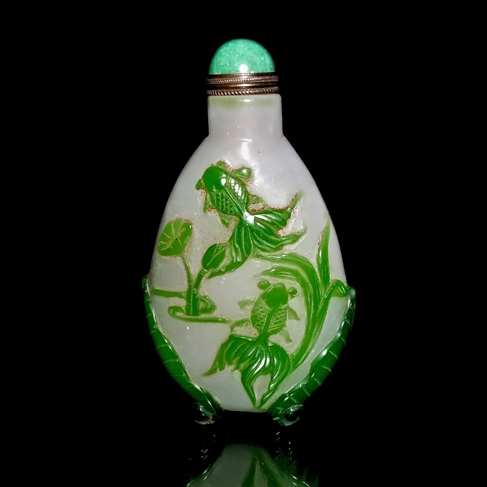 Peking glass overlay snuff bottle, Koi fish: The well carved bottle is footed and carved on both sides with Koy fish. The bottle is footed. The bottle is 3.75 tall.