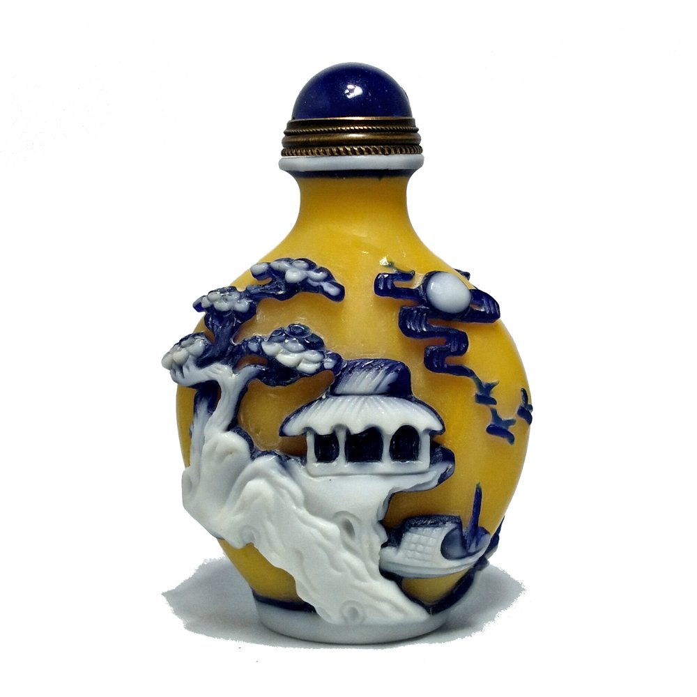 EXQUISITE PEKING GLASS SNUFF BOTTLE IMPERIAL YELLOW: THIS OUTSTANDING SNUFF BOTTLE IS MASTERFULLY CARVED IN HIGH RELIEF IN BLUE AND WHITE OVER IMPERIAL YELLOW. IT DEPICTS TWO MARITIM SCENES WITH BOATS, A BRIDGE, PINES, PALACES AND CLOUDS. THE BOTTLE HAS