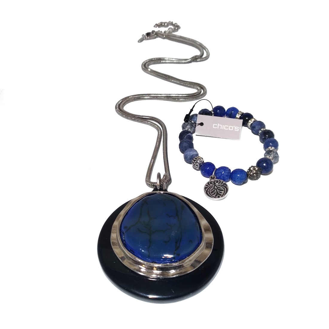 BEAUTIFUL JEWELRY LOT IN BLUES BY CHICO'S: The stunning necklace and bracelet both by Chico's. The bracelet features natural stones and crystals and a medallion. Both aresilver tone and in excellent condition. Size: Necklace - 40". Bracelet - 