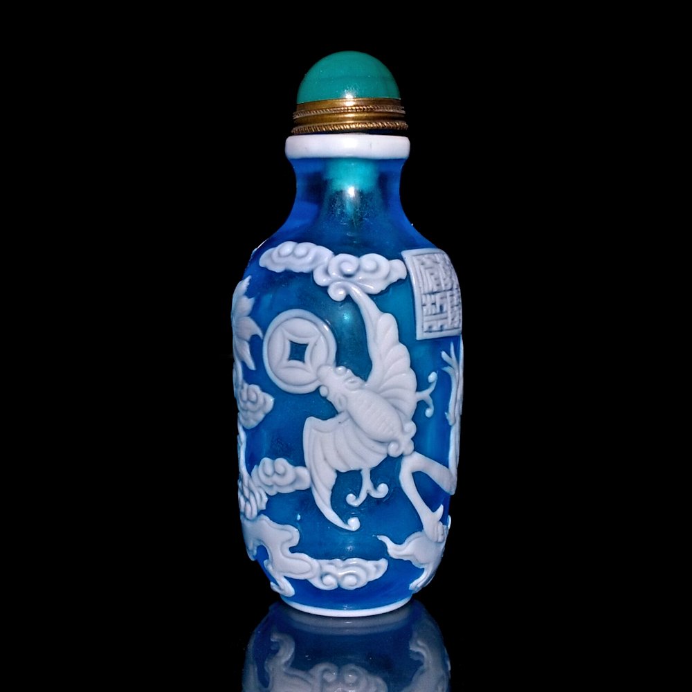 CHINESE PEKING GLASS OVERLAY BOTTLE DRAGON BATS: THE STUNNING BOTTLE IS MADE OF A BEAUTIFUL SHADE OF LIGHT BLUE GLASS. THE DRAGON AND BATS ARE CARVED IN WHITE GLASS OVERLAY. THE BOTTLE BEARS A QIANLONG MARK. IT IS 3.25 INCHES TALL. PROVENANCE:PRIVAT