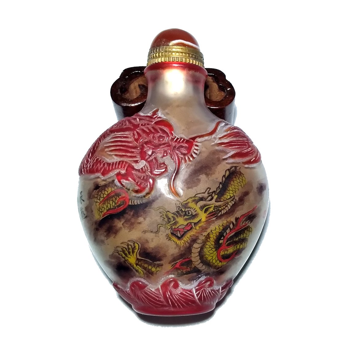 CHINESE OVERLAY INSIDE PAINTED SNUFF BOTTLE IMPERIAL DRAGON: THIS BOTTLE IS BEAUTIFULLY CARVED IN RED GLASS OVER CLEAR. IT FEATURES TWO IMPERIAL DRAGONS ON THE INSIDE, CHASING THE FLAMING PEARL THE BOTTLE IS SIGNED AND INCRIBED WITH A POEM. ON THE OUTSIDE IT IS