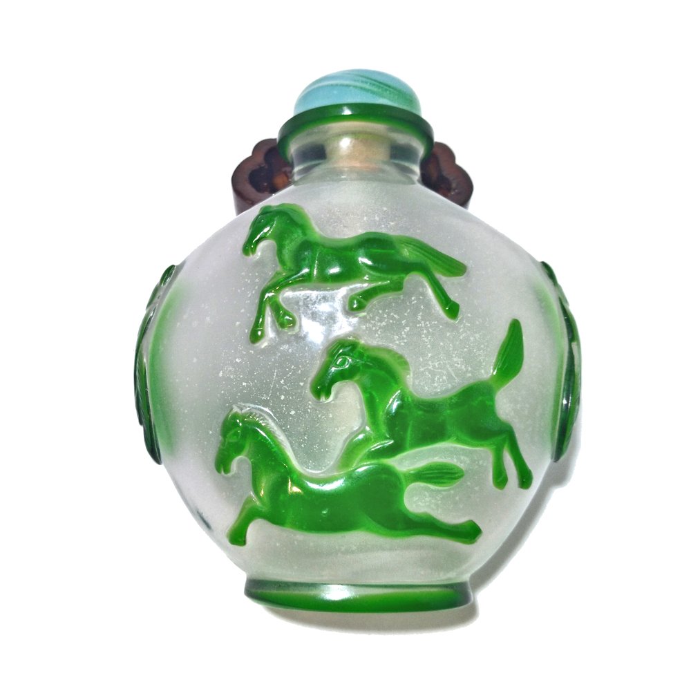 VERY FINE RARE PEKING GLASS OVERLAY HORSES QING: THE OUTSTANDING RARE BOTTLE IS CARVED IN GREEN OVERLAY OVER BUBBLE INFUSED SNOW STORM GLASS. THERE IS SO MUCH MOVEMENT IN THE BEAUTIFUL HORSE CARVINGS AND MOST UNUSUALLY THE SHOULDERS ARE CARVED WITH 