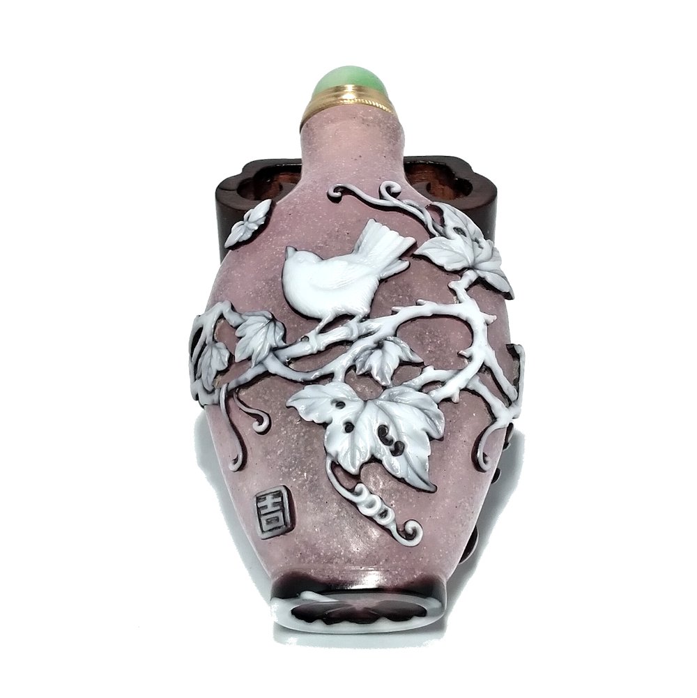 FINE PINK PEKING GLASS SNUFF BOTTLE BIRDS VINES BUTTERFLIES: THE SIGNED AND INTRICATELY CARVED BOTTLE FEATURES A VERY DETAILED SCENE OF BIRDS, VINES AND BUTTERFLIES. IT IS CARVED IN 3 LAYERS OF GLASS WITH A ROSE/PINK BACKGROUND. THE BOTTLE FEATURES A WELL CARVE