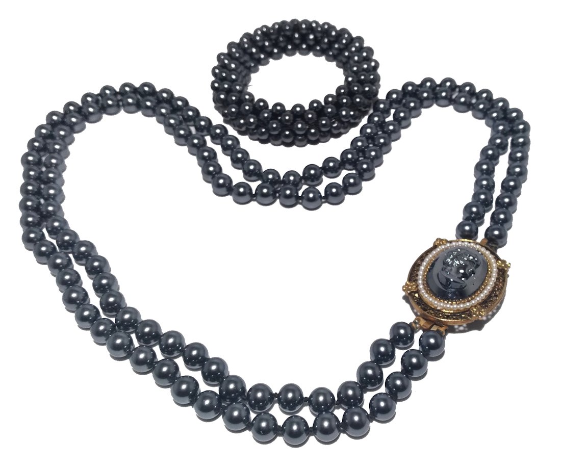 BEAUTIFUL VINTAGE CAMEO HEMATITE NECKLACE W BONUS BRACELET: THIS BEAUTIFUL LOT INCLUDES A VINTAGE TWO STRAND CAMEO NECKLACE IN HEMATITE AND GOLD TONE. THE CLASP CAN BECOME A BROOCH AS WELL. AS A BONUS WE ADDED A FAUX PEARL BRACELET THAT MATCHES VERY WELL. THE