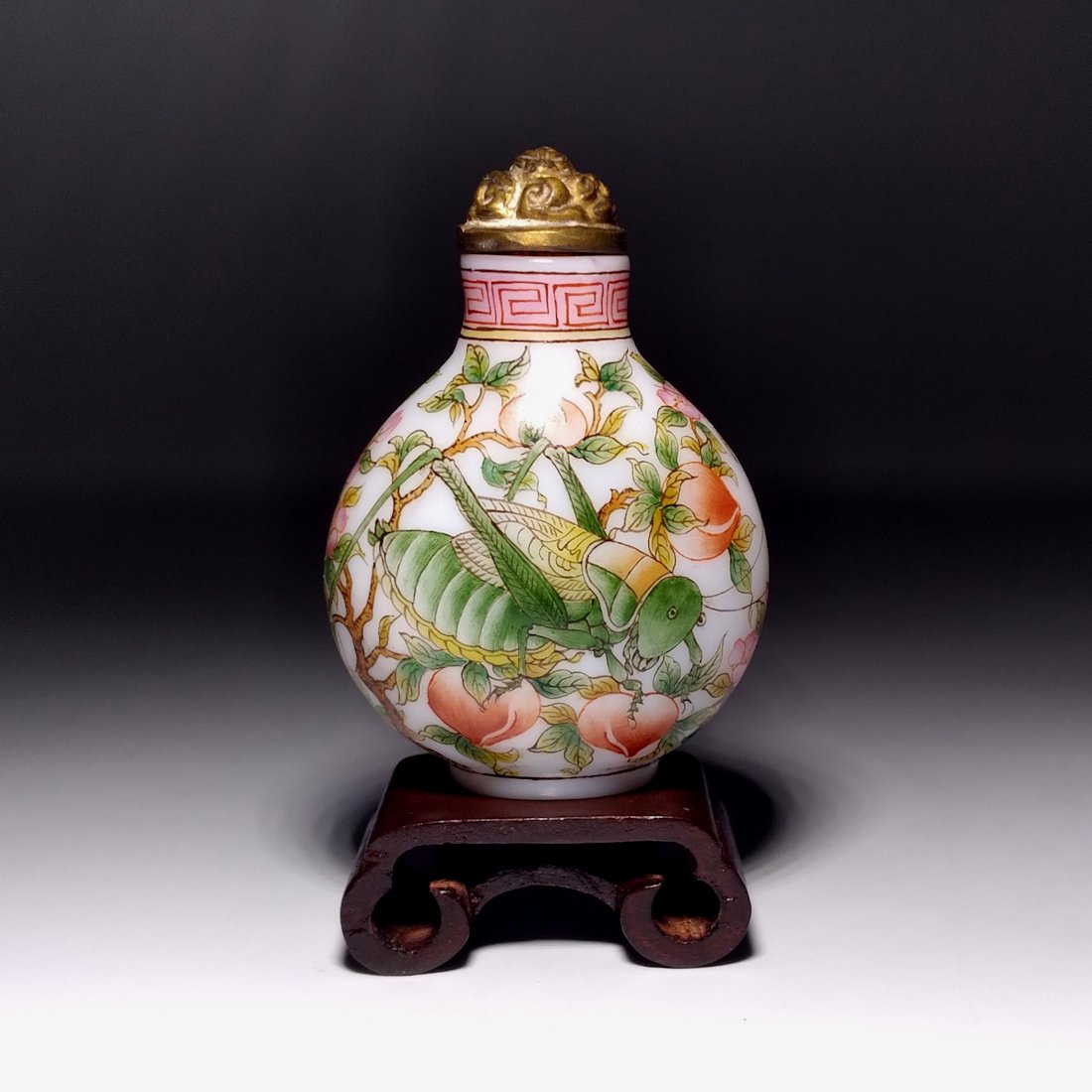 VERY FINE CHINESE ENAMEL GLASS SNUFF BOTTLE CRICKET: THE YELLOW GROUND BOTTLE IS FINELY ENAMELED WITH SCENES OF CRICKETS ON A PEACH TREE, IT BEARS A QIANLONG DATE MARK. THE BOTTLE IS 2.5 INCHES TALL. PROVENANCE: MAJOR PRIVATE COLLECTION.