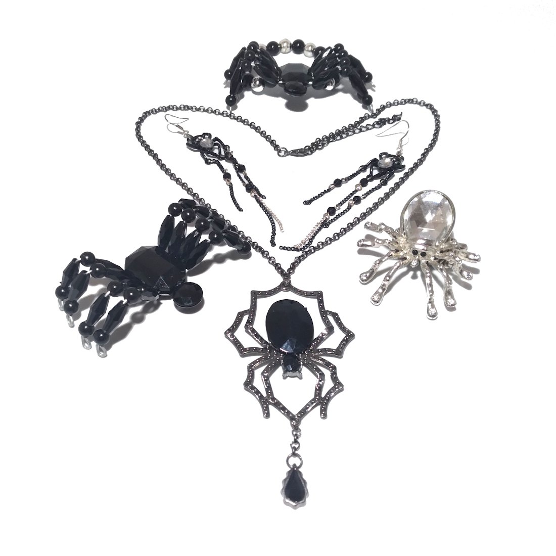 A VERY COOL LOT OF SPIDER THEMED COSTUME JEWELRY: THERE IS A SET OF MATCHING BRACELET AND RING, BOTH STRECHABLE/ADJUSTTABLE. THERE IS ANOTHER ADJUSTABLE RING WITH A CRYSTAL BODY/ THERE ARE EARRINGS AND A LOVELY NECKLACE, 22 INCHES LONG. ALL IN VERY G