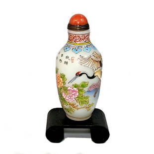 A FINELY ENAMELED GLASS SNUFF BOTTLE MULTI FLORAL: THE OUTSTANDING BOTTLE IS BEAUTIFULLY HAND PAINTED WITH A VERY DETAILED STORK AND FLORAL SCENE. IT IS INSCRIBED WITH A SIGNED POEM. IT IS DATED QIANLONG. IT IS 3.3 INCHES TALL. PROVENANCE: FLORIDA