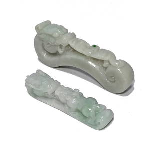 GROUP OF TWO CHINESE EXQUISITE JADEITE BELT BUCKLES: THE TWO EXCELLENT BELT BUCKLES ARE WELL CARVED WITH SMOOTH LINES OUT OF NATURAL, UNDYED JADEITE. THE FEATURE DRAGONS AND A BAT. ONE BUCKLE IS 3.5 INCHES LONG AND THE OTHER IS 2.5 INCHES LONG. THE COLO