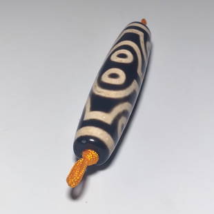 FINE SINO TIBETAN MASTER AGATE DZI BEAD 68MM 8 EYES: THE BEAUTIFUL BEAD SHOWING FINE PATINA. IT IS 68MM LONG AND FEATURES 8 EYES. PROVENANCE: PRIVATE FLORIDA COLLECTION. WE PROVIDE IN-HOUSE SHIPPING.