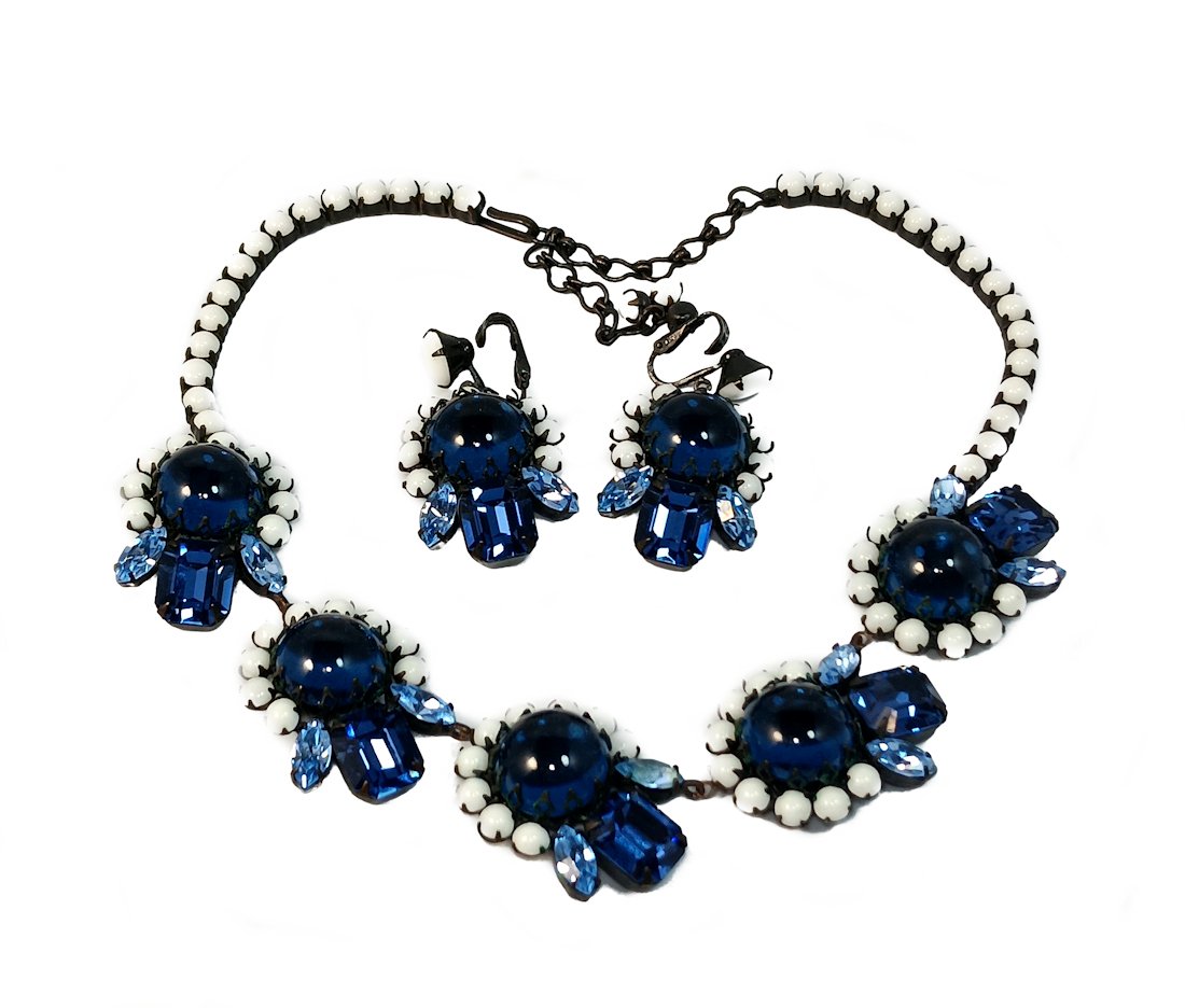 AN OUTSTANDING RARE ALICE CAVINESS PARURE: WHAT A BEAUTY! A SIGNED ALICE CAVINESS PARURE WITH SAPPHIRE BLUE CABOCHONS. THE NECKLACE IS 16" AROUND, EXTENSION INCLUDED. JAPANED SETTING. THE EARRINGS ARE CLIPS. WE PROVIDE IN-HOUSE SHIPPING.