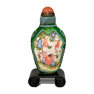 A FINELY CHINESE ENAMELED AND CARVED GLASS SNUFF BOTTLE CHILDREN AT PLAY: THE OUTSTANDING BOTTLE IS BEAUTIFULLY HAND PAINTED AND CARVED. IT DEPICTS CHILDREN AT PLAY. THE BOTTLE IS SIGNED. IT IS 3.5 INCHES TALL. PROVENANCE: FLORIDA PRIVATE COLLECTOR. WE PROVIDE IN-HOUSE SHIP