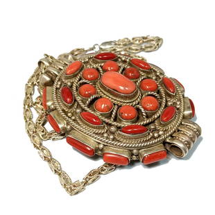 A STUNNING SOUTHWESTERN NECKLACE OF CORAL AND STERLING: THE SUPERB NECKLACE WEIGHS 94.60 GRAMS AND MARKED 925. THE CORAL STUDDED PENDANT IS 3" BY 2.4" IN SIZE.THE PENDANT ALSO OPENS, AS A BOX OR LOCKET. THE STERLING SILVER NECKLACE IS 24" LONG. WE PROVIDE