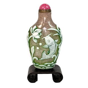 A FINE CHINESE PEKING GLASS SNUFF BOTTLE STORK CARP FLORA: THIS IS AN EXQUISITELY CHINESE CARVED SNUFF BOTTLE, IN THREE LAYERS OF GLASS IN 3 COLORS. IT DEPICTS A STORK A CARP, FLORA, WAVES AND ROCKS. IT IS 3.5 INCHES TALL. PROVENANCE: A PRIVATE COLLECTION,