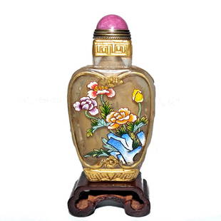 FINE CHINESE ENAMEL ON GLASS SNUFF BOTTLE FLORA DRAGONS QIANLONG MARK: THE FINELY ENAMELED CHINESE SNUFF BOTTLE OVER GLASS, FEATURES FLORAL SCENES WITH FANTASTIC DETAIL. THE BOTTLE IS ALSO CARVED AND GILDED WITH DRAGONS ON BOTH SHOULDERS. IT HAS AN UNUSUAL SQUAREDNECK. B