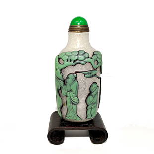 CHINESE PEKING GLASS OVERLAY SNUFF BOTTLE IMMORTALS: THE BEAUTIFULLY CHINESE CARVED SNUFF BOTTLE DEPICTS IMMORTALS, PINE AND ROCKS, CARVED IN 3 LAYERS OF GLASS. THE BOTTLE IS 3.3 INCHES TALL. PROVENANCE: PRIVATE FLORIDA COLLECTION. WE PROVIDE INHOUSE