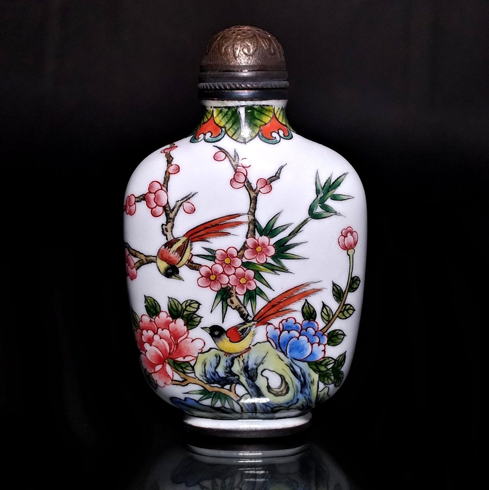BEAUTIFUL CHINESE ENAMEL ON COPPER SNUFF BOTTLE BIRDS PEONY QIANLONG MARK: THE BEAUTIFULLY ENAMELED SNUFF BOTTLE FEATURES BIRDS AND FLORA ALL AROUND. IT BEARS A QIANLONG MARK. IT IS 2.6 INCHES TALL. STANDS ARE FOR DISPLAY ONLY, NOT INCLUDED UNLESS OTHERWISE STATED. PROPERTY 