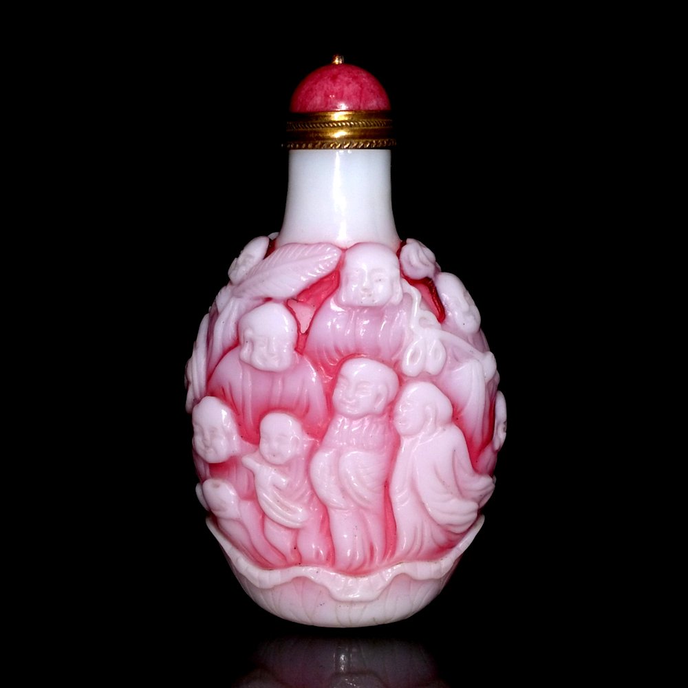 BEAUTIFUL CHINESE PEKING GLASS SNUFF BOTTLE PINK WHITE 18 ARHATS LOHANS: THE BEAUTIFULLY CARVED CHINESE SNUFF BOTTLE FEATURES THE 20 ARHATS OR LOHANS, ORIGINALS FOLLOWERS OF THE BUDDHA. IT IS CARVED IN THREE LAYERS. THE BOTTLE IS 2.9 INCHES TALL. STANDS ARE FOR DISPLAY ONL