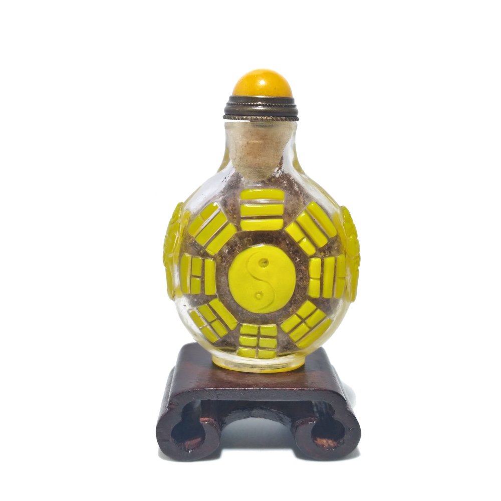 CHINESE YELLOW PEKING GLASS SNUFF BOTTLE YIN YANG: THE CHINESE SNUFF BOTTLE IS SO WELL CARVED WITH YIN YANG SYMBOL AND MORE. THE FOOT IS A WELL CARVED OVAL. IT IS 2.25 INCHES TALL. STANDS ARE FOR DISPLAY ONLY, NOT INCLUDED UNLESS OTHERWISE STATED. PRO
