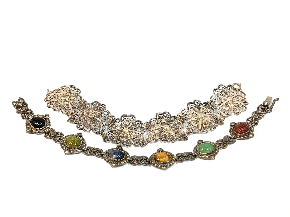 A MARCASITE SCARAB GEMSTONE BRACELET 7.5" AND A FILIGREE BRACELET: THE VINTAGE MARCASITE BRACELET IS SET WITH SCARAB CARVED GEMSTONES: ONYX, JADE, CARNELIAN, LAPIS AND AGATE. IT IS MARKED A 925 AND IT WEIGHS 22 GRAMS. THE FILIGREE BRACELET IS 7" LONG. IT HAS A LOWER