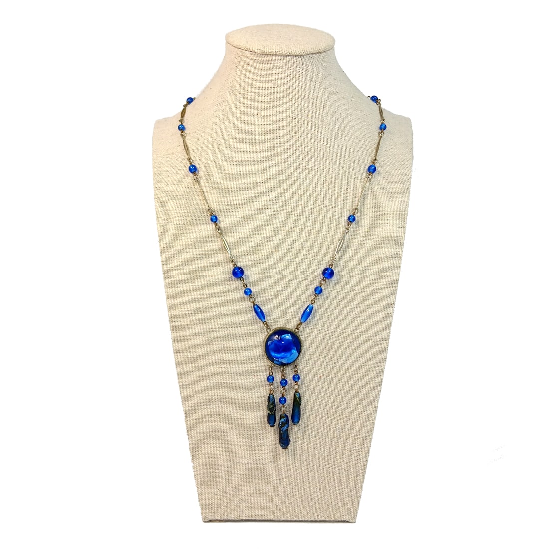 AN ANTIQUE BLUE FOIL GLASS NECKLACE CIRCA THE 1920S: THE STUNNING ANTIQUE NECKLACE MEASURES APPROXIMATELY 20" LONG AND THE PENDANT PART IS 2.75" LONG. WE PROVIDE IN-HOUSE/COMBINED SHIPPING FOR YOUR CONVENIENCE. CHECK OUT OUR OTHER LISTINGS OF VINTAGE AN