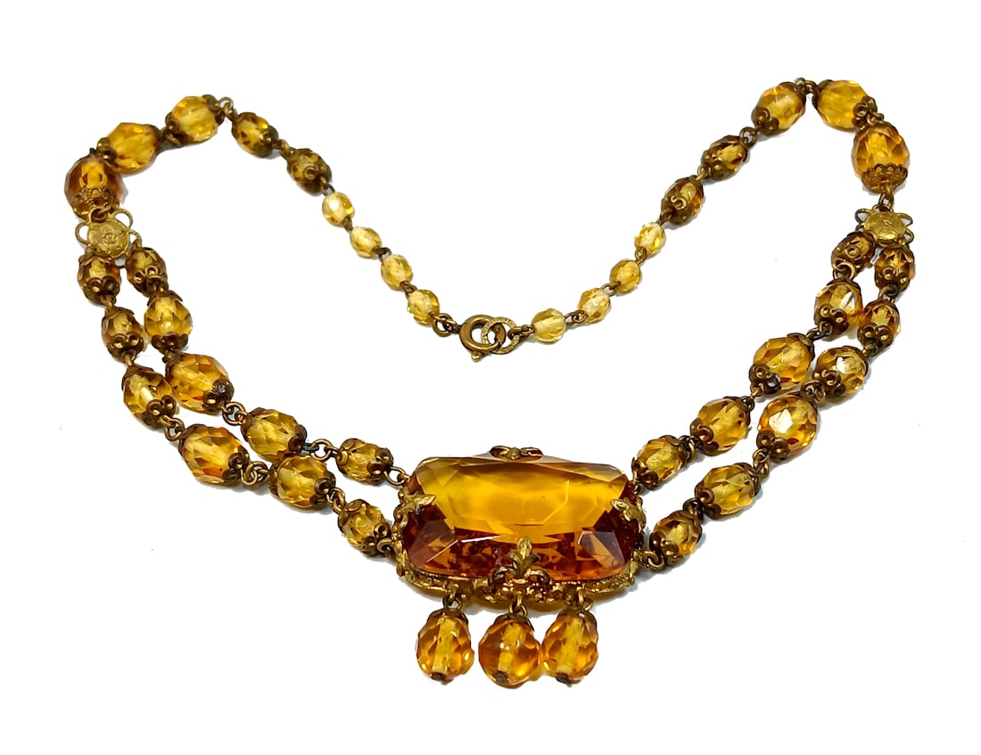A BEAUTIFUL ART DECO SIGNED CZECH NECKLACE: OFFERED HERE IS A BEAUTIFUL CZECH NECKLACE FROM THE ART DECO ERA. IT IS MARKED ON THE CLOSURE RING. THE NECKLACE IS MADE OF FACETED GLASS IN A TOPAZ CITRINE COLOR. IT IS 15" LONG.WE PROVIDE IN-HOUSE/C