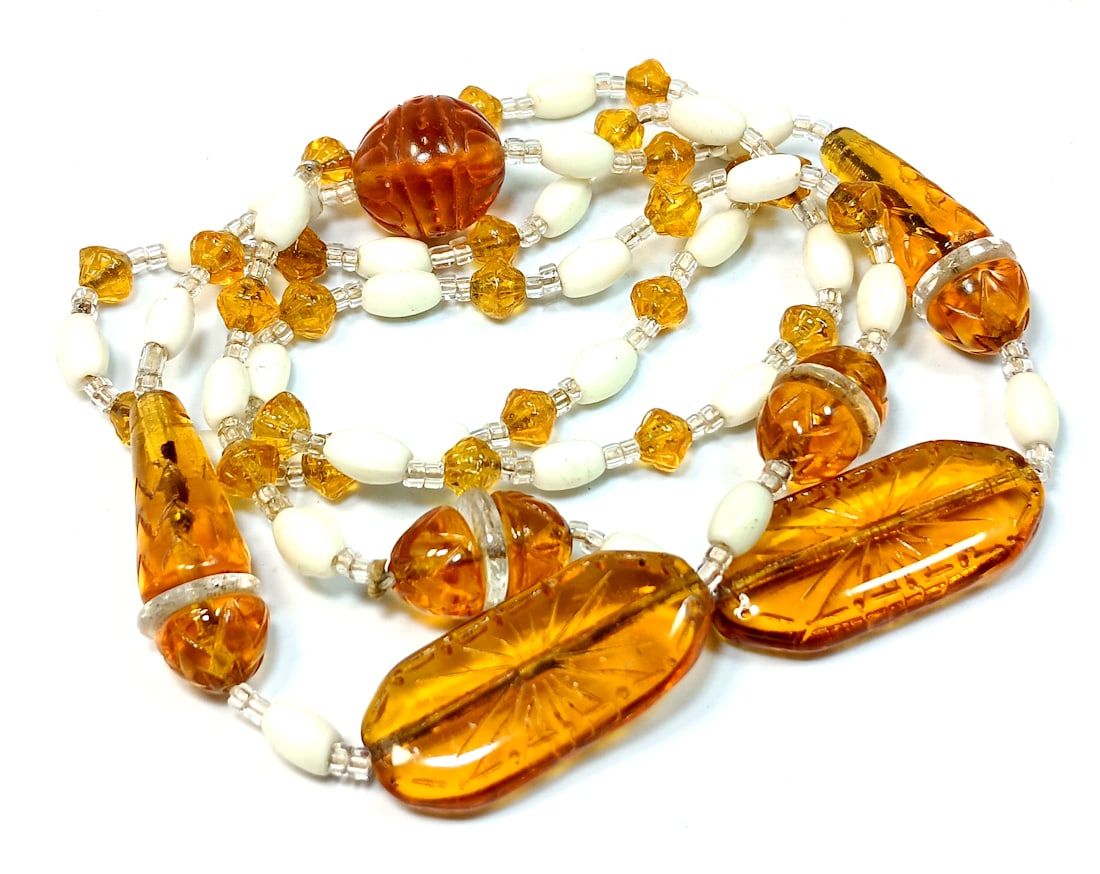 A STUNNING ART DECO BEADED CZECH GLASS NECKLACE: OFFERED HERE IS A STUNNING ART DECO BEADED CZECH GLASS NECKLACE. THE NECKLACE IS MADE OF GLASS BEADS IN VARIOUS SHAPES, SOME OF WHICH ARE ETCHED. IT IS 28" LONG. IT FEATURES AN ART DECO PATTERN. NOT M