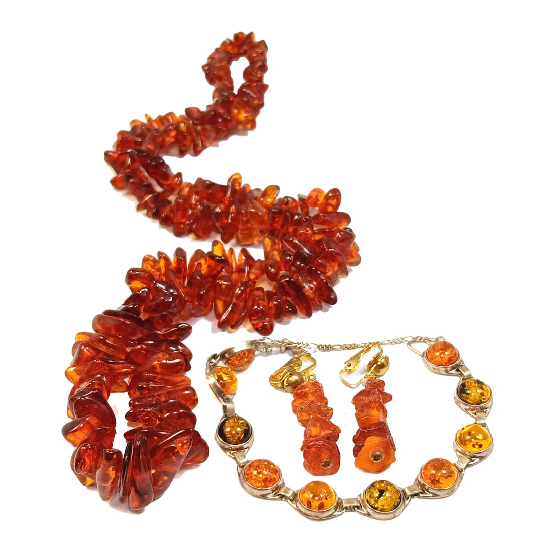 A FABULOUS LOT OF BALTIC AMBER NECKLACE EARRINGS AND STERLING BRACELET: OFFERED HERE IS A BEAUTIFUL LOT OF BALTIC AMBER NECKLACE EARRINGS AND A STERLING BRACELET. THE LARGE NECKLACE IS 27" LONG AND IT WEIGHS 57 GRAMS. THERE ARE EARRINGS AND A STERLING AND AMBER BRACELET T