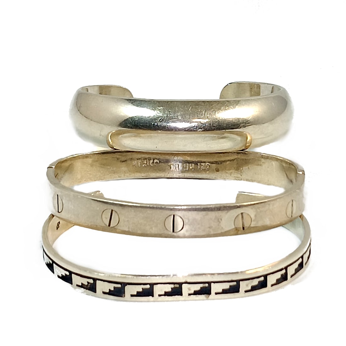 A LOT OF 3 STERLING SILVER MEXICAN & HOPI SOUTHWESTERN BRACELETS: OFFERED HERE IS A LOT OF 3 STERLING SILVER MEXICAN & SOUTHWESTERN BRACELETS THEY WEIGH A TOTAL OF 68.5 GRAMS. TWO ARE MEXICAN AND ONE IS SIGNED AND NATIVE AMERICAN HOPI. INNER DIAMETERS ARE 2.4", 2.3"