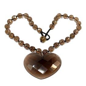 A NECKLACE OF FACETED SMOKEY QUARTZ BEADS AND A HEART PENDANT
