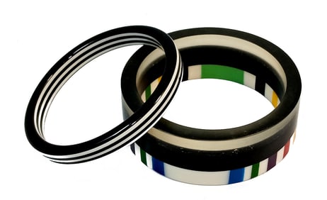 A STUNNING LOT OF 2 LAMINATED LUCITE BANGLES 2.5" D