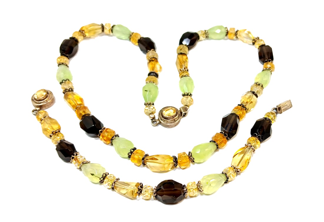 A GEMSTONE SET NECKLACE BRACELET STERLING SILVER TOURMALINE CITRINE: OFFERED HERE IS A BEAUTIFUL GEMSTONE SET FEATURING A NECKLACE AND A MATCHING BRACELET, SET STERLING SILVER. THE STONES ARE TOURMALINE, CITRINE AND SMOKEY QUARTZ. THE NECKLACE IS 19" LONG AND THE BRACE